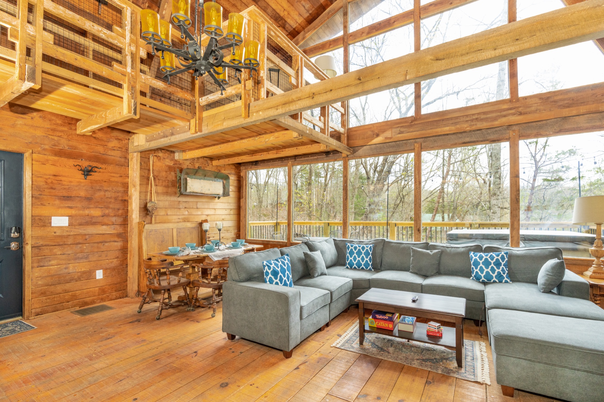 Rustic Retreat's living and dining area viewed from above, with the spiral staircase to the loft